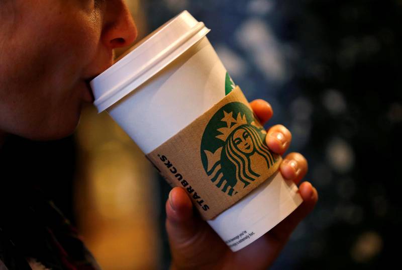 FILE PHOTO: A customer sips her coffee in Starbucks' Mayfair Vigo Street branch in central London, Britain, September 12, 2012. REUTERS/Andrew Winning/File Photo