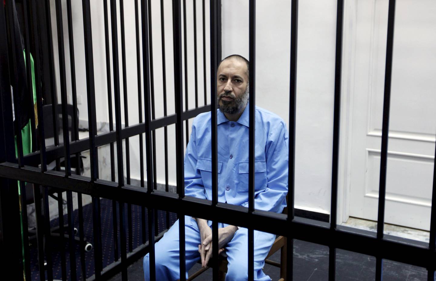 Saadi Gaddafi, son of Muammar Gaddafi, sits behind bars during a hearing at a courtroom in Tripoli in 2016.  Reuters, File 