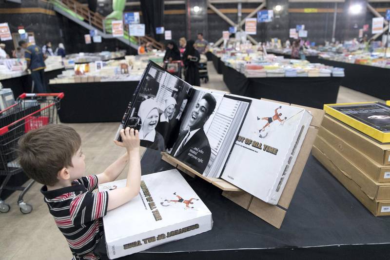 DUBAI, UNITED ARAB EMIRATES - OCTOBER 18, 2018. Shopper browse the books at Big Bad Wolf.The Big Bad Wolf Sale Dubai has over 3 million brand new, English and Arabic books across all genres, from fiction, non-fiction to children's books, offered at 50%-80% discounts.(Photo by Reem Mohammed/The National)Reporter: ANAM RIZVISection:  NA