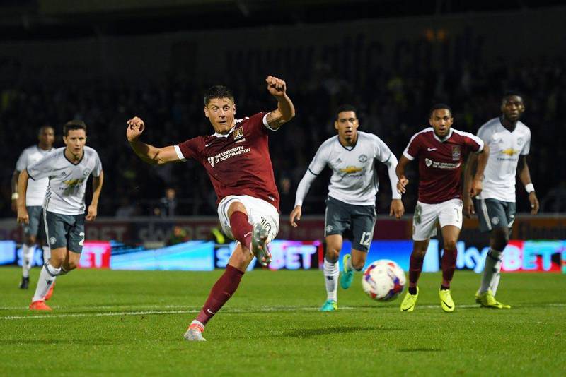Alex Revell of Northampton Town scores his side’s first goal against Manchester United. Laurence Griffiths / Getty Images