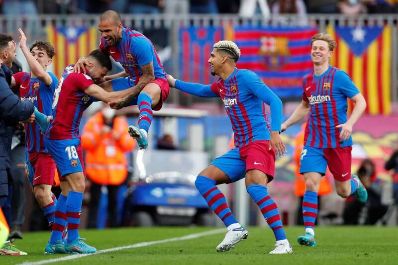 Dani Alves celebrates after scoring Barcelona's fourth goal in their 4-2 La Liga win over Atletico Madrid at Camp Nou on Sunday, February 6, 2022. EPA