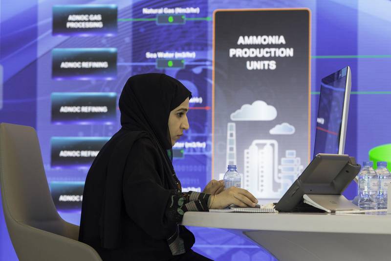 A female employee works at a computer in the Panorama Command Center near a panoramic digital screen displaying ammonia production units at the Abu Dhabi National Oil Company (ADNOC) headquarters in Abu Dhabi, United Arab Emirates, on Thursday, Feb. 22, 2018. Adnoc is seeking to create world’s largest integrated refinery and petrochemical complex at Ruwais. Photographer: Christopher Pike/Bloomberg