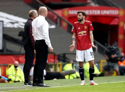 Manchester United's Bruno Fernandes speaks to Burnley manager Sean Dyche during the match. PA