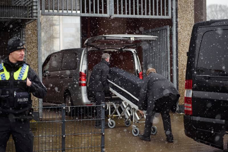 Undertakers carry coffins out of the building in Hamburg. Getty