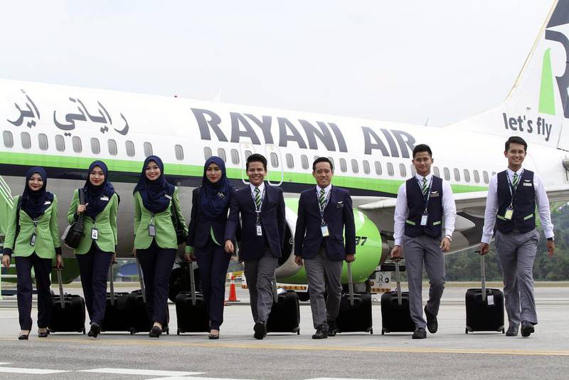 Rayani Air cabin crew in front of a Boeing 737-400 at Kuala Lumpur International Airport. EPA