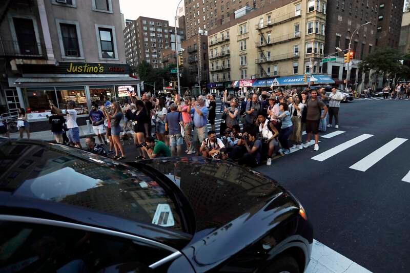 People gather on a city crosswalk along 57th Street during Manhattanhenge. EPA
