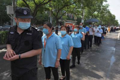 People wait in line for the nasal swab PCR test. China's capital partially lifted a weeks-long lockdown that was put in place to head off a feared second wave. AFP