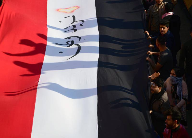 epa08094159 Iraqi university students chant slogans next to a banner reading in Arabic 'we want a homeland', as they take part in a demonstration at the Al Tahrir square in central Baghdad, Iraq, 29 December 2019. Thousands of Iraqi university students participated in a protest and strike as part of the ongoing protests across the country, against the Iraqi government corruption, which started since 01 October 2019.  EPA/MURTAJA LATEEF