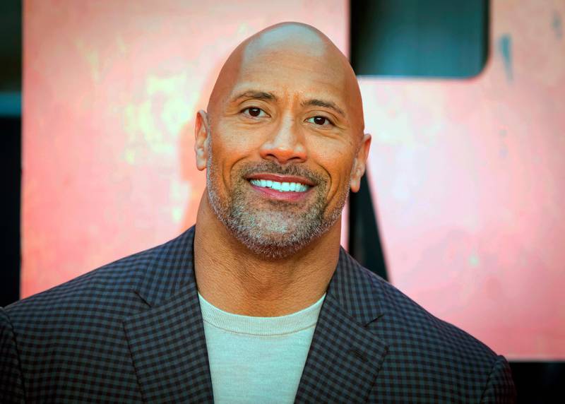 FILE - In this April 11, 2018, file photo, actor Dwayne Johnson poses for photographers at the premiere of the "Rampage," in London. Johnson will host and Justin Bieber, Miley Cyrus and Jennifer Hudson will perform on a globally broadcast concert calling on world leaders to make coronavirus tests and treatment available and equitable for all. The advocacy organization Global Citizen and the European Commission announced Monday, June 22, 2020 that Global Goal: Unite for Our Future â€” The Concert will air on June 27. (Photo by Vianney Le Caer/Invision/AP, File)