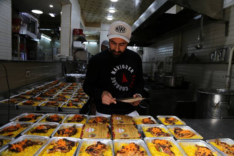 Ismail Abdel-Wahhab, 39, a former football coach, provides meals for families every Friday, in Helwan, a suburb of Cairo.  All photos: Reuters