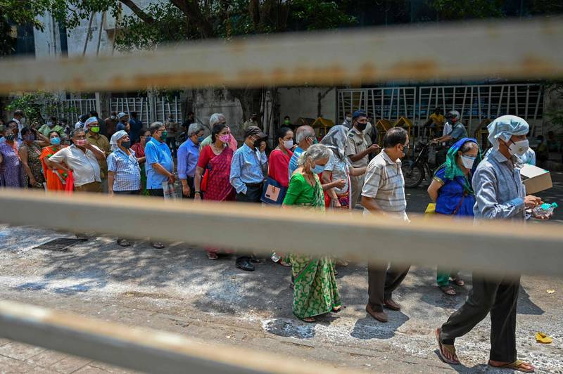 People queue up to get inoculated with a dose of India's Covishield vaccine in Mumbai. AFP