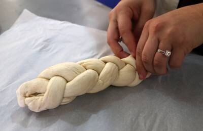 Staff preparing challah bread at the centre. Pawan Singh / The National