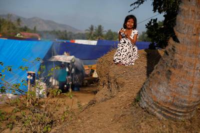 A girl cries as she waits for breakfast at a refugee camp at Sigar Penjalin village in North Lombok, Indonesia, August 10, 2018. Reuters