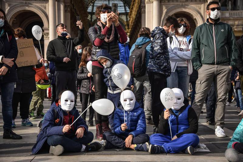 People take part in a demonstration against distanced learning in Duomo square, Milan, northern Italy. EPA