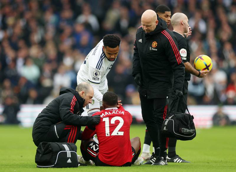 Manchester United's Tyrell Malacia receives medical attention. Reuters