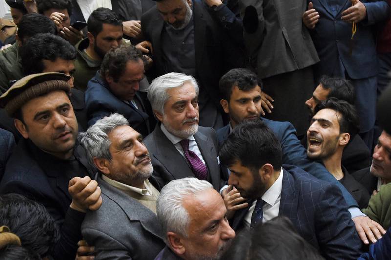 Afghan presidential election opposition candidate Abdullah Abdullah (C) arrives to give a press conference after the announcement of the final presidential elections results at the Sapedar Palace in Kabul on February 18, 2020. Afghan presidential election loser Abdullah Abdullah on February 18 contested final results that declared his rival Ashraf Ghani the winner of last year's poll, vowing he would form his own parallel government. Afghan election officials said final results showed he had won 39.52 percent of last September's vote, while Ghani had taken 50.64 percent. / AFP / WAKIL KOHSAR
