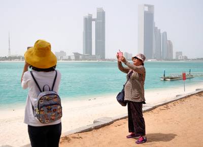 Abu Dhabi, United Arab Emirates, July 23, 2019.  Chinese tourists enjoy the sights at the Heritage Village, Corniche, in spite of the humid weather.Victor Besa/The NationalSection:  NAReporter: