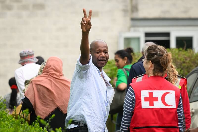 A V sign for victory as people rescued from Sudan arrive at Stansted Airport in south-east England. Getty Images