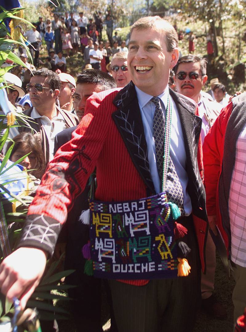 Wearing a traditional Guatemalan ceremonial jacket, Prince Andrew turns on the tap inaugurating an irrigation system in Nevaj, Guatemala, in 2002.