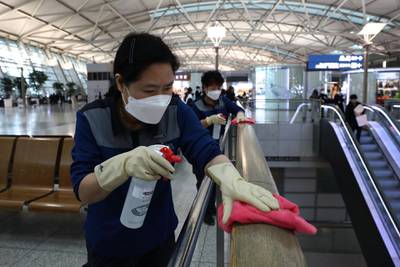 Disinfection workers wearing masks spray antiseptic solution at Incheon International Airport in Incheon, South Korea. Getty Images