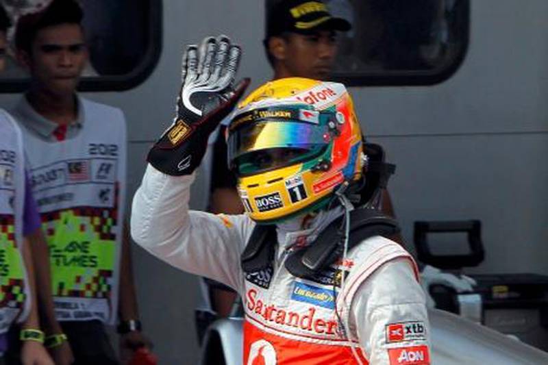 McLaren Formula One driver Lewis Hamilton of Britain waves after taking the pole position in the qualifying session of the Malaysian F1 Grand Prix at Sepang International Circuit outside Kuala Lumpur March 24, 2012.  REUTERS/Samsul Said (MALAYSIA  - Tags: SPORT MOTORSPORT)   *** Local Caption ***  SEP77_MOTOR-RACING-_0324_11.JPG