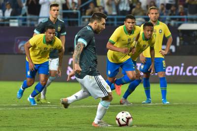 Argentina's forward Lionel Messi runs up to take a penalty during the match between Brazil and Argentina. He missed the spot kick but scored from the rebound. AFP