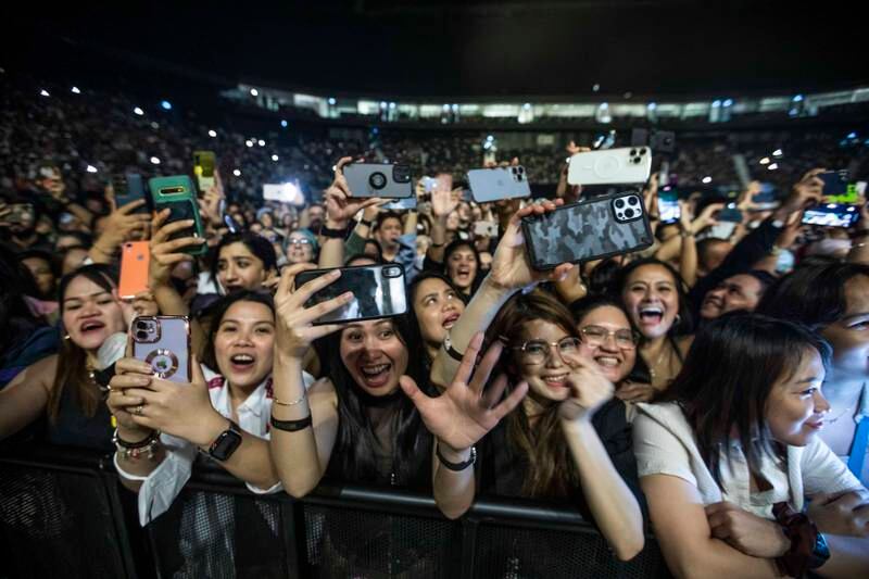 Excited fans in the front row of the concert for Westlife.