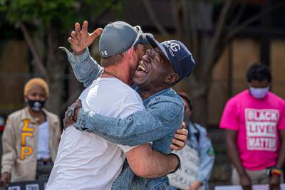 Black Lives Matter demonstrators Tim Higgins (L) and Michael Jone (R) embrace near Centennial Olympic Park in the wake of the Atlanta Police deadly shooting of Rayshard Brooks in Atlanta, Georgia, USA. EPA