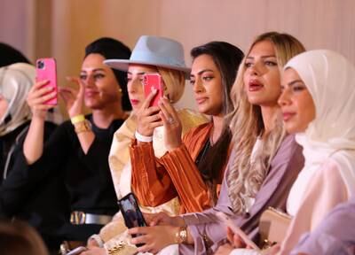 Phones at the ready - fashion fans take in the action.