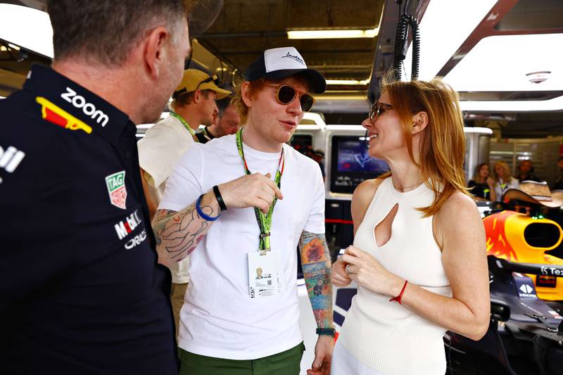Musician Ed Sheeran talks with Geri Horner and Red Bull Racing team principal Christian Horner in the Red Bull Racing garage prior to the F1 Grand Prix of USA at Circuit of The Americas on October 23, 2022 in Austin, Texas. AFP