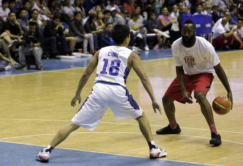 James Harden of the Houston Rockets, above, dribbles against a Philippines national basketball team member on Tuesday night during an exhibition drill in Quezon City, Philippines. Ritchie B Tongo / EPA / July 22, 2014
