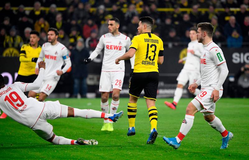 Dortmund's Portuguese defender Raphael Guerreiro scores to make it 1-0. AFP
