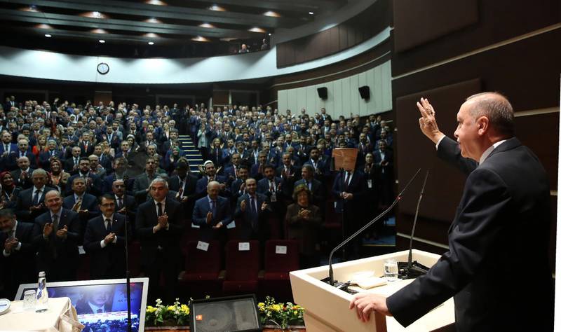 Turkey's President Recep Tayyip Erdogan gestures as he addresses the members of his ruling party, in Ankara, Turkey, Thursday, Dec. 26, 2019. Erdogan says Thursday his government will submit a bill to parliament that would allow Turkey to send troops to Libya, in support of the U.N.-backed government there. Erdogan said the Libyan government, which controls the capital, Tripoli, has "invited" Turkey to send troops. (Turkish Presidency via AP, Pool)