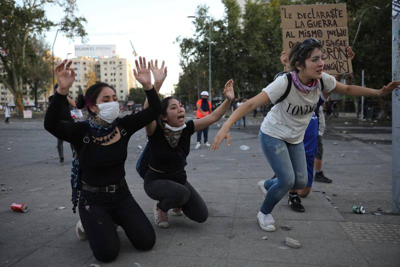 Women ask police to stop dispersing their anti-government protest. AP Photo