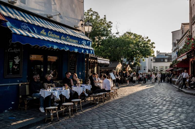 Customers dine on restaurant terraces in the Montmartre district of Paris, France. Bloomberg
