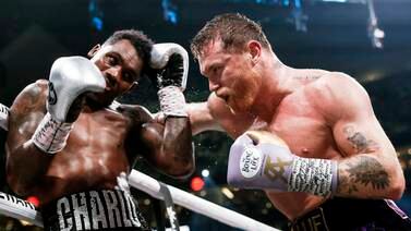 Saul 'Canelo' Alvarez, right, applies pressure on Jermell Charlo in a one-sided victory for the Mexican. EPA