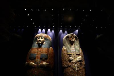 The painted and gilded cedar outer coffin lid of Pinudjem II's wife, Princess Nesikhonsu, left, and the inner coffin lid or mummy board of Pinudjem I. AFP