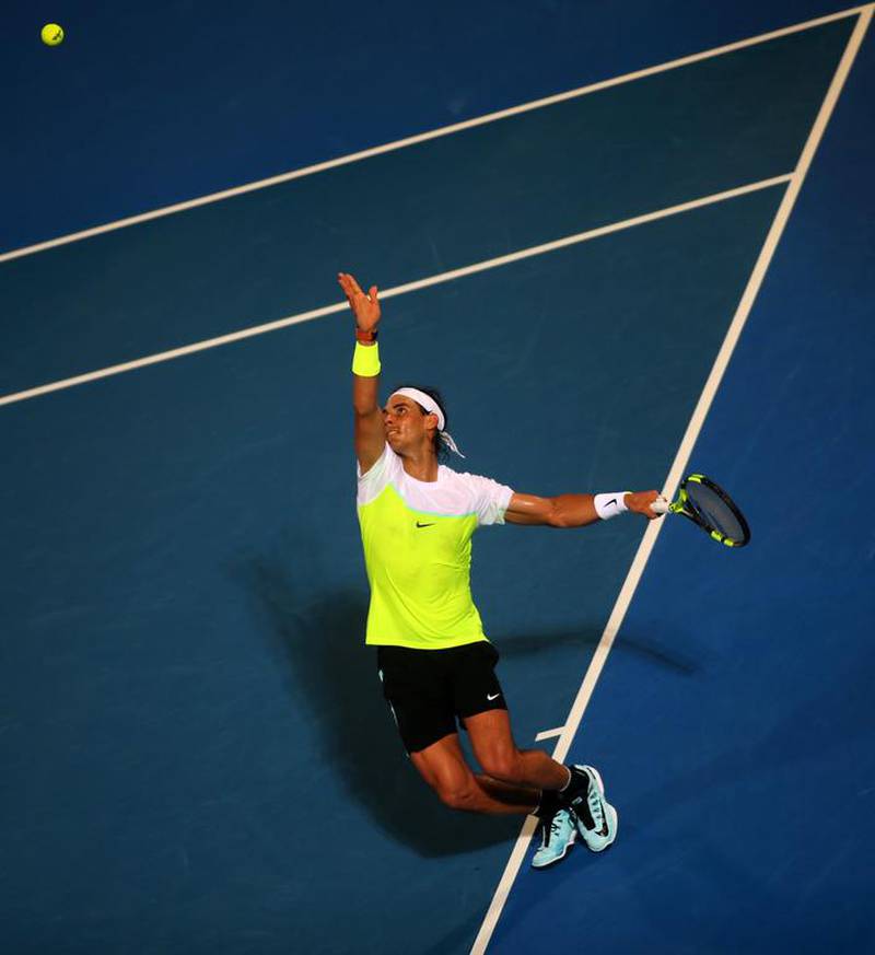 Rafael Nadal serves to David Ferrer during their semi-final. Marwan Naamani / AFP
