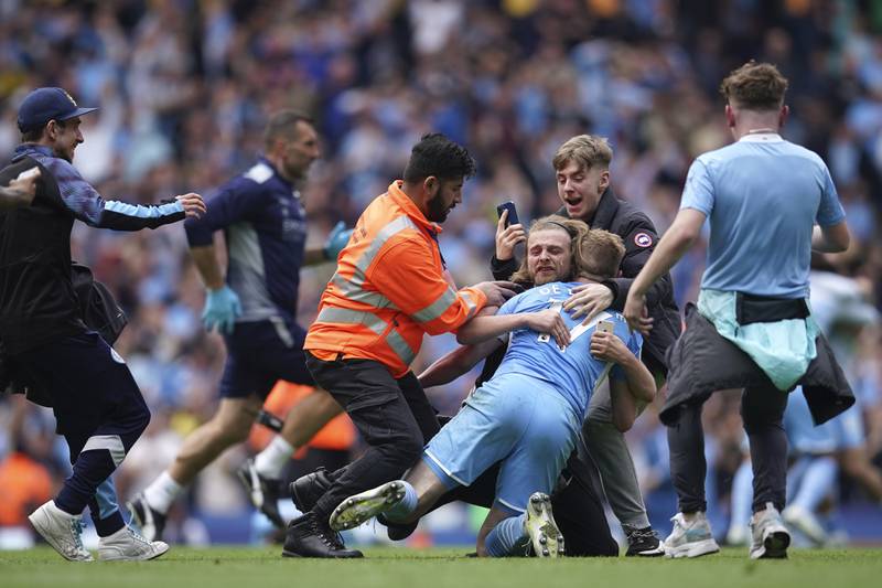 Manchester City's Kevin De Bruyne celebrates with fans after winning the Premier League. AP