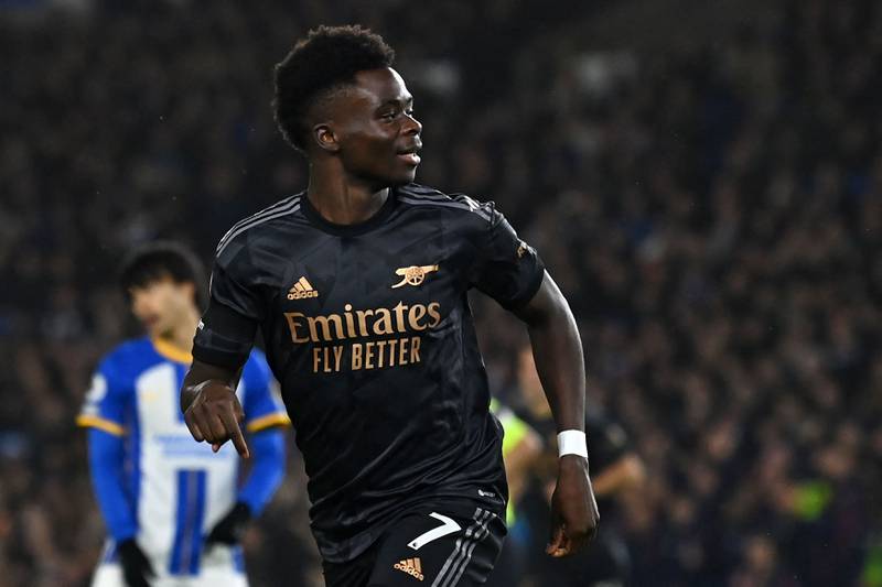 Bukayo Saka celebrates after scoring Arsenal's opening goal in their 4-2 Premier League win over Brighton at the American Express Community Stadium on December 31, 2022. AFP