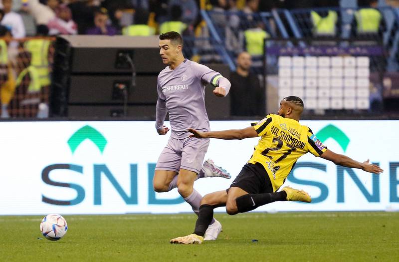 Al Nassr's Cristiano Ronaldo skips past Al Ittihad's Hamdan Al Shammari. Reuters