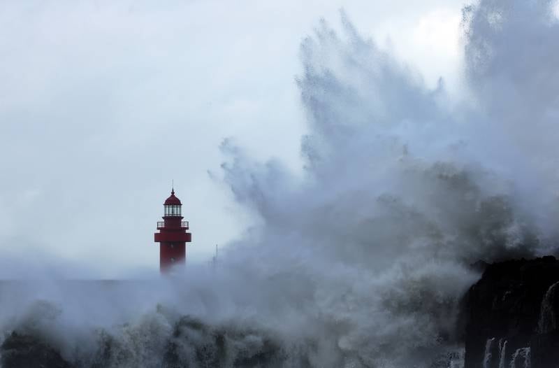 A wave crashes into a port on Jeju Island. Reuters