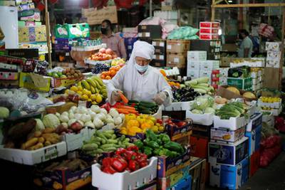 A Bahraini man, wearing a face mask, following the outbreak of the coronavirus disease (COVID-19), shops at a vegetables stand, in Central Market, in Manama, Bahrain. REUTERS