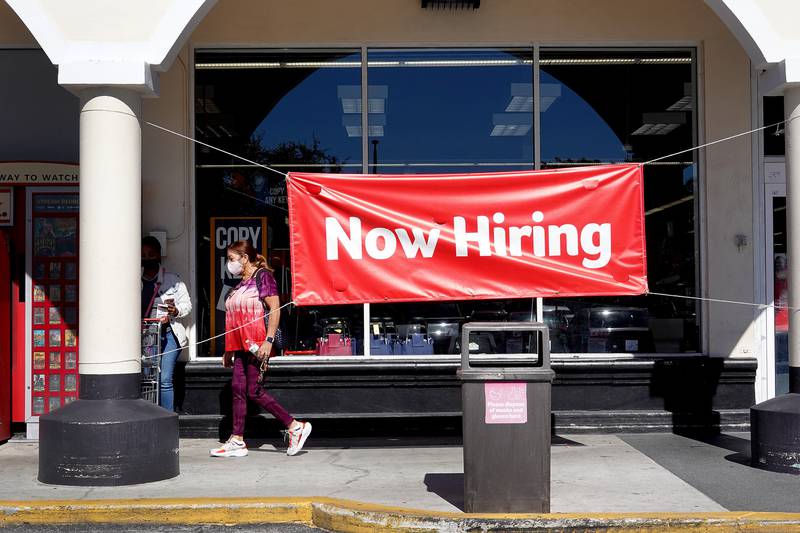 A 'Now Hiring' sign hangs in front of a Winn-Dixie grocery store in Miami, Florida. AFP