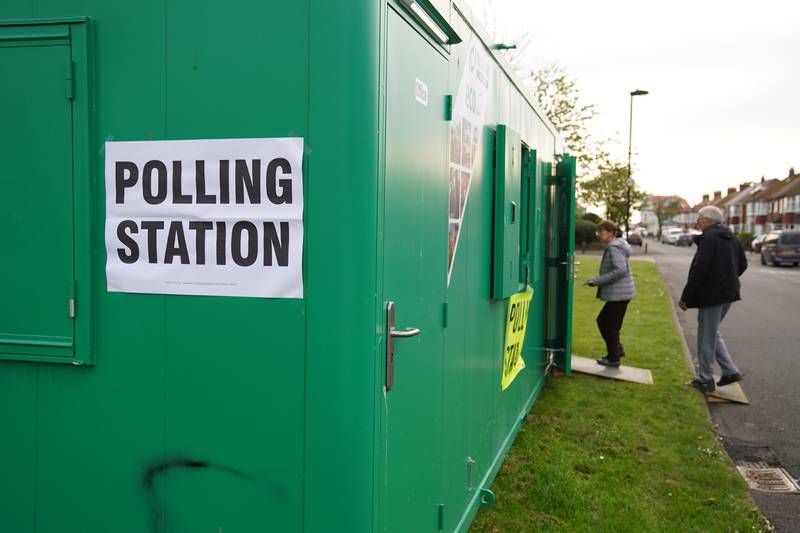 Voters arrive at a polling station in a temporary building in Whitley Bay, Northumberland. PA