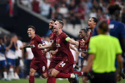 Liverpool's English midfielder Jordan Henderson and teammates celebrate winning the UEFA Super Cup. AFP