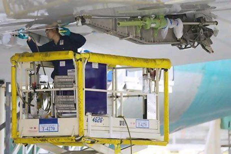 Strata has been sub-contracted to produce spoilers, the wing flaps that reduce lift and help control descents, for Boeing's 787 Dreamliner. Above, a Boeing technician works on a wing of an airplane being produced in Everett, Washington.