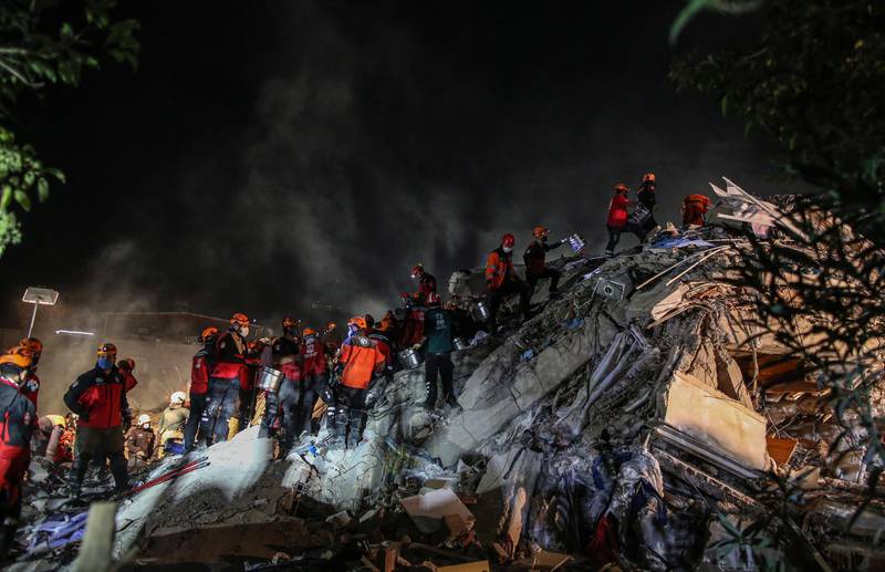 Rescue workers and people search for survivors at a collapsed building after a 7.0 magnitude earthquake in the Aegean Sea, at Bayrakli district in Izmir, Turkey. EPA