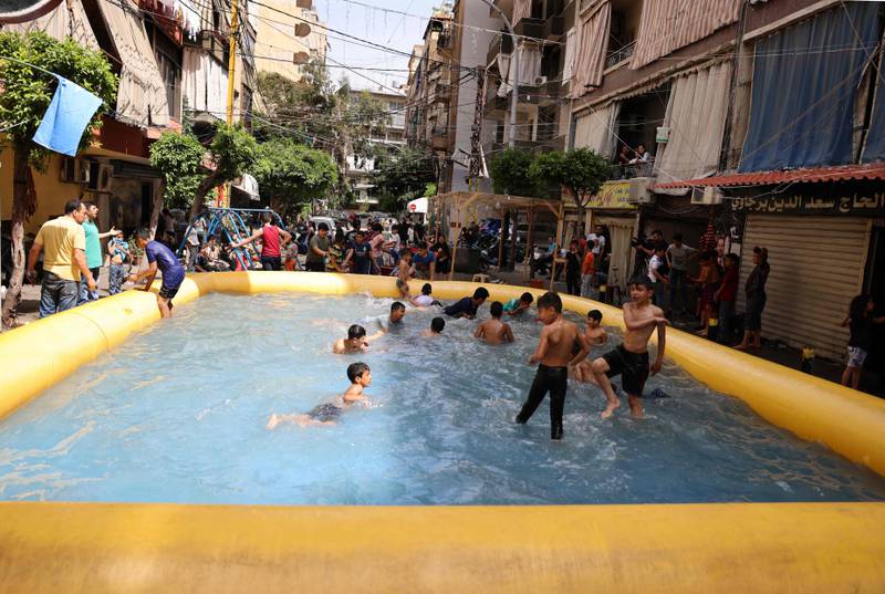 Beirut children play in an inflatable swimming pool set up by supporters of former Lebanese prime minister Saad Hariri, who have boycotted the country's elections. AFP 