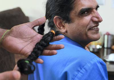 Abu Dhabi, United Arab Emirates, February 4, 2021.  Dr Yogesh Shastri, a gastroenterologist at NMC Speciality Hospital Abu Dhabi, together with his wife Sarika have grown their hair for two years to donate to a wig making charity to help paediatric cancer patients.  -- After the cut.Victor Besa/The NationalSection:  NAReporter:  Gillian Duncan